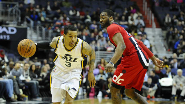 Utah Jazz guard Trey Burke (3) dribbles past Washington Wizards guard John Wall (2) during the second half at Verizon Center. The Washington Wizards won 103-89.